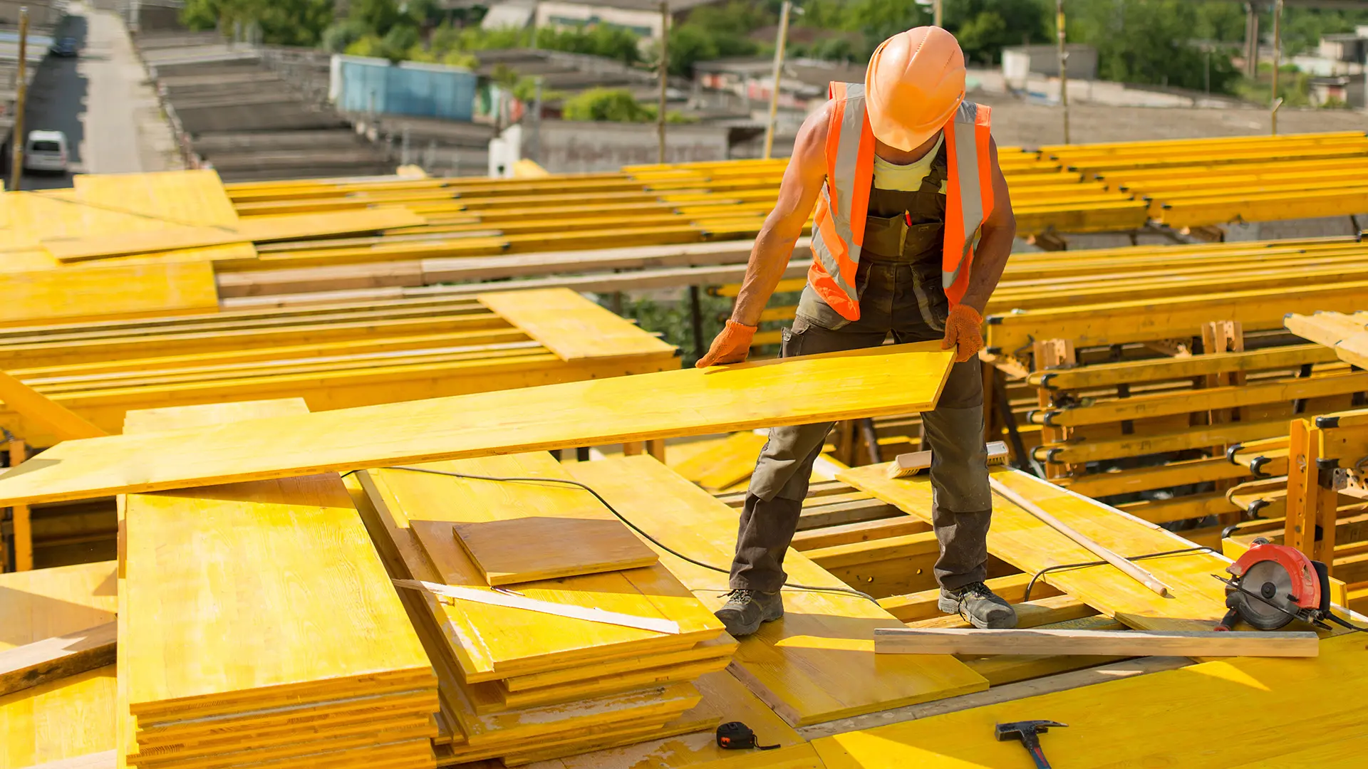 3-ply yellow formwork panel used on a construction site for routine concrete formwork, showing easy handling during repeated setups