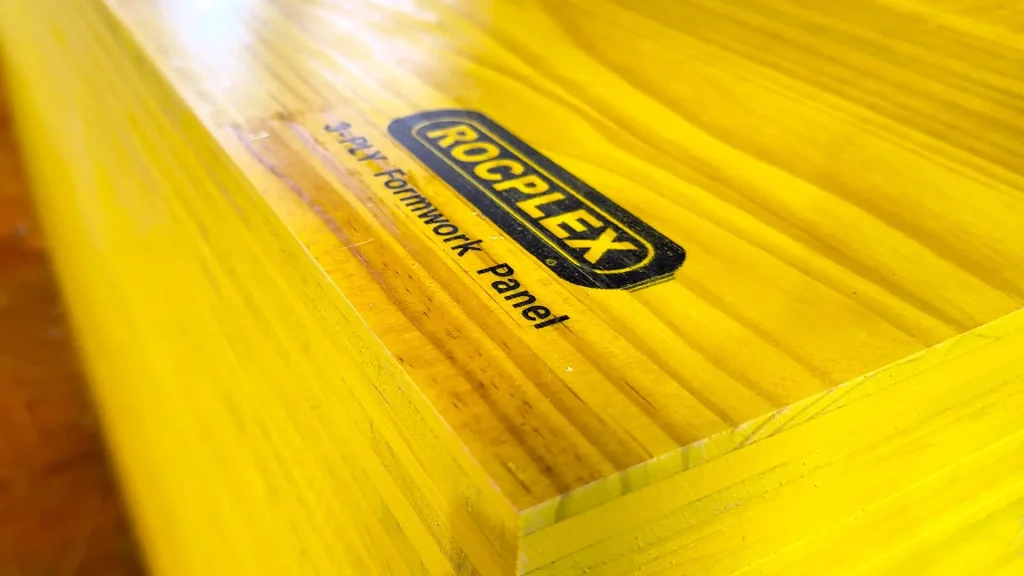 Close-up of ROCPLEX 3-ply formwork panel, featuring smooth, durable yellow film-faced plywood